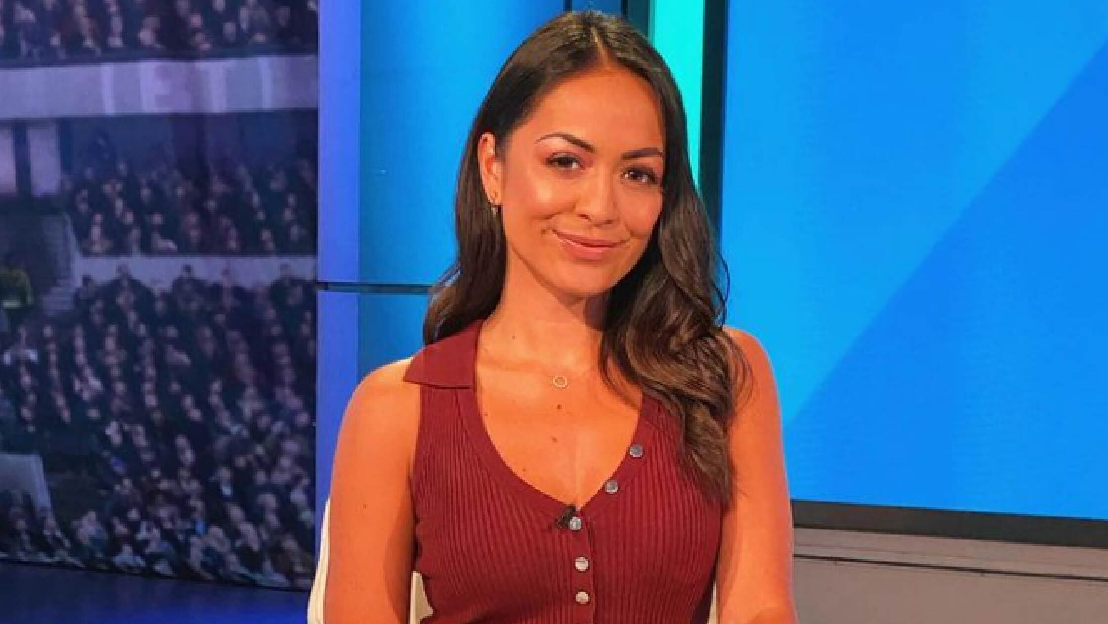 Jules on a TV show in a red top. 