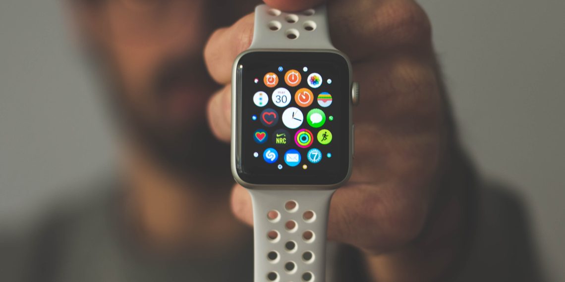 a person holding apple watch