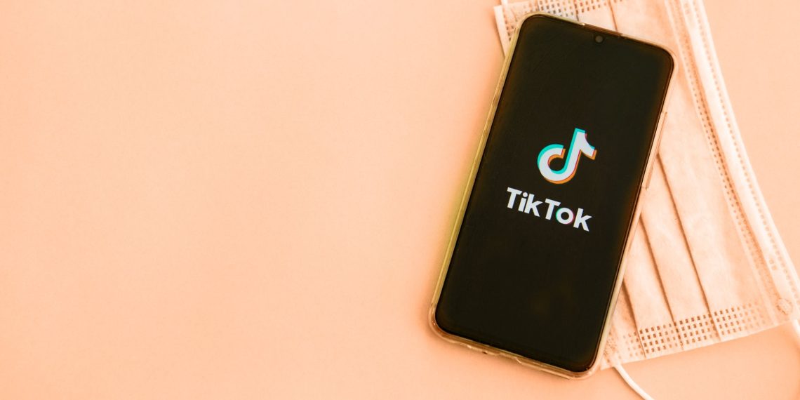 A phone showing tik tok logo on the screen