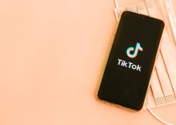 A phone showing tik tok logo on the screen