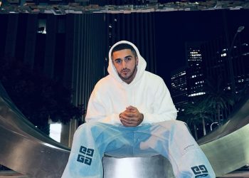 Aisan Eslami wearing white hoodie and blue jeans.