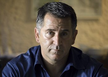 Anthony Lapaglia wearing a blue shirt and looking straight in camera.